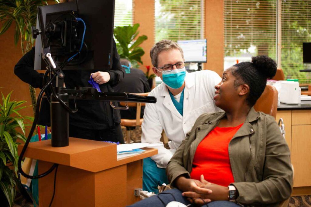 Orthodontist Dr. Labbe smiling with a family whose daughter is receiving treatment