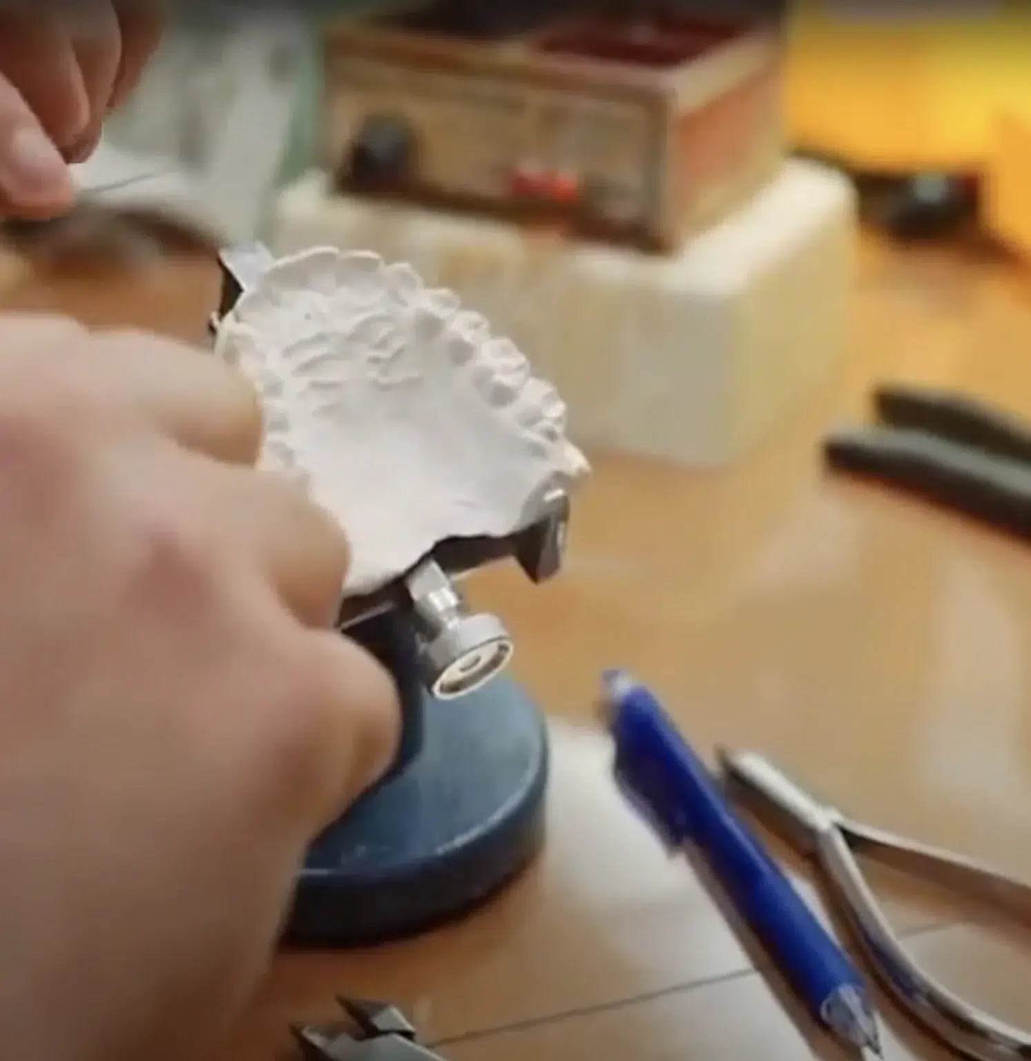 Custom orthodontic mold being used to craft retainers for a patient after treatment