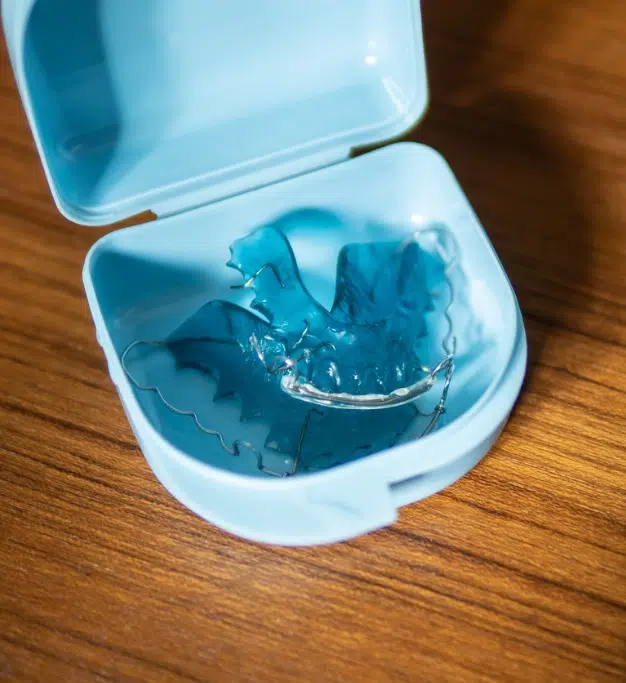 Set of sleek blue removable Hawley Retainers in a light blue case