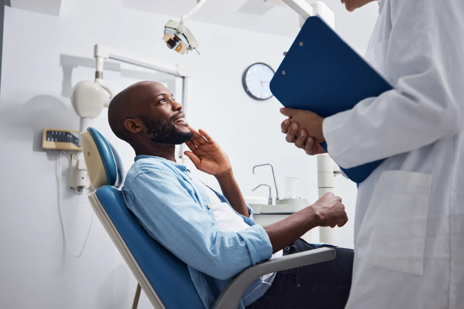 Patient talking to doctor about orthdontic procedure.